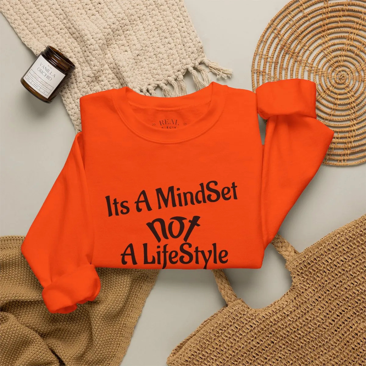 Second folded mockup of the orange crewneck sweatshirt